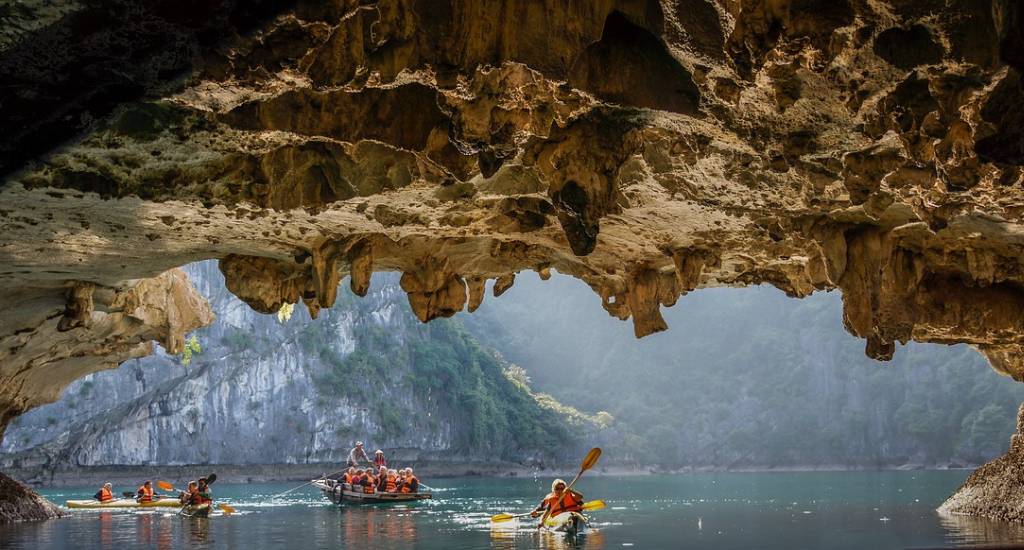 Tourists kayaking as part of a Halong Bay Group Tour
