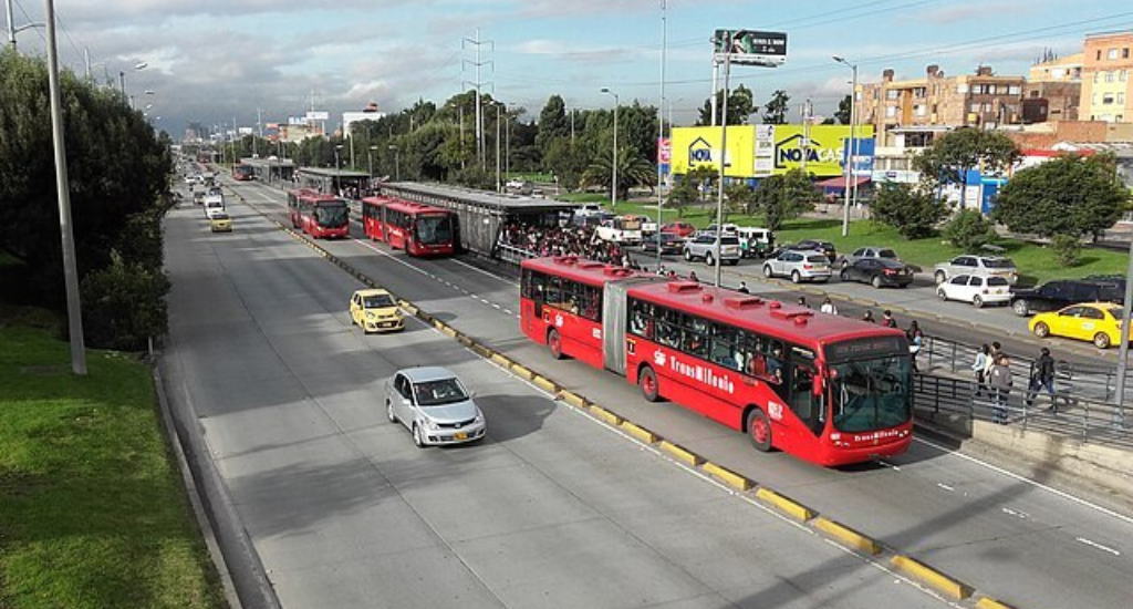 Buses loading passengers in a BRT station in Bogota, Colombia